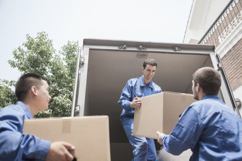 Removal team carrying household items through a local Totteridge property